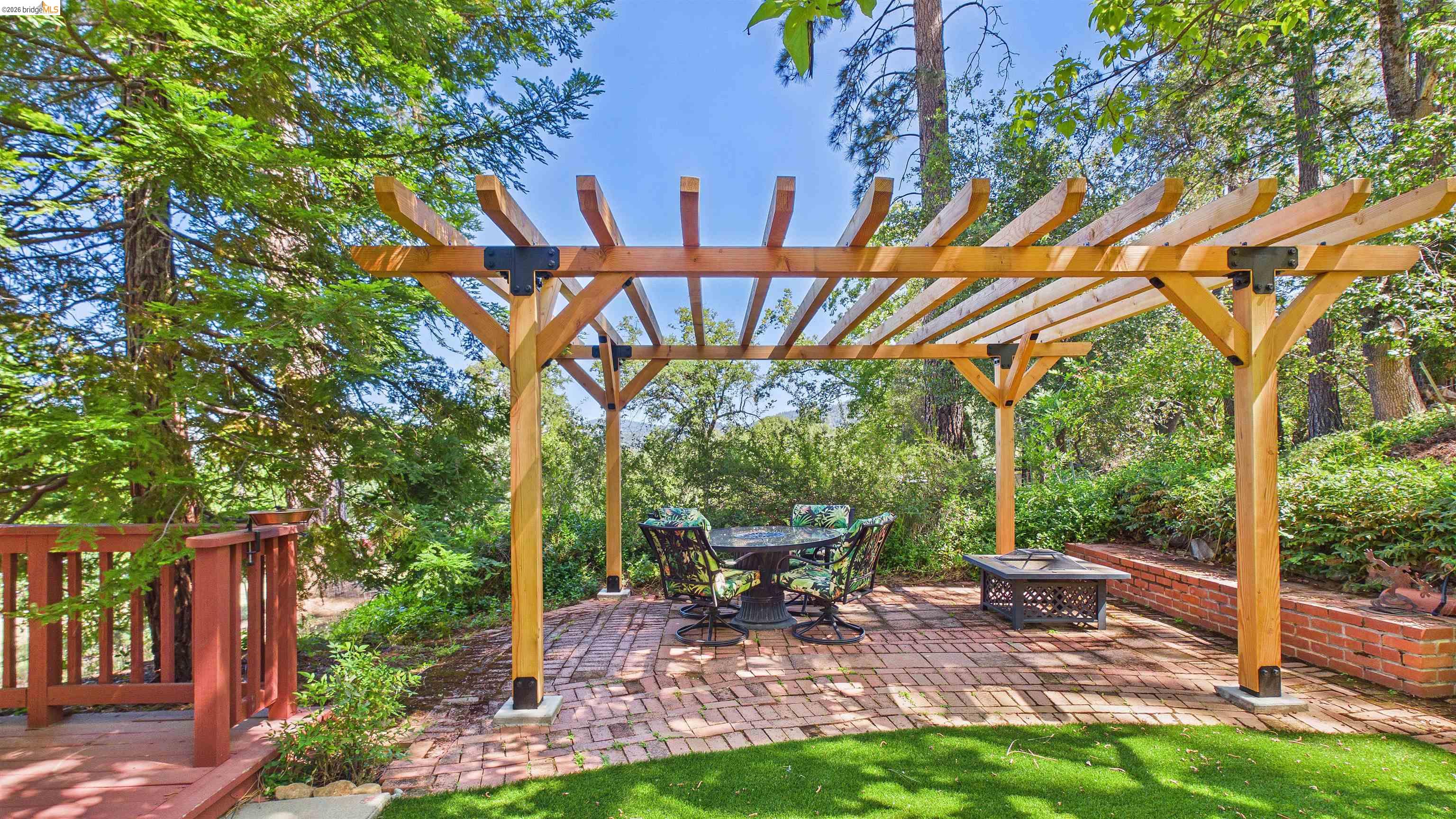 18102 Mt Eaton Road Tuolumne, CA 95379 - Photo 25 of 44 Outdoor pergola structure over a brick patio with a raised brick garden bed