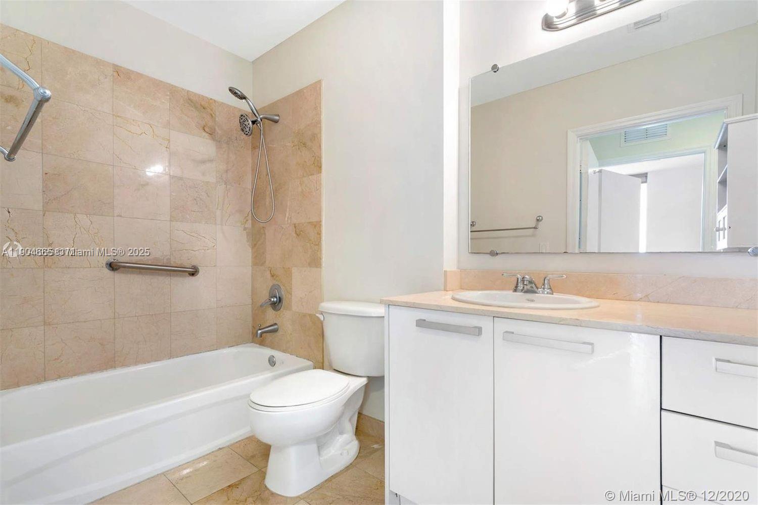 2525 Southwest 3rd Avenue, Unit 605 Miami, FL 33129 - Photo 5 of 19 a bathroom with a sink a toilet and a bathtub