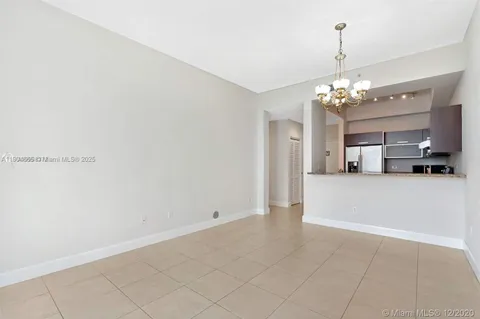 a view of a kitchen with a sink and chandelier