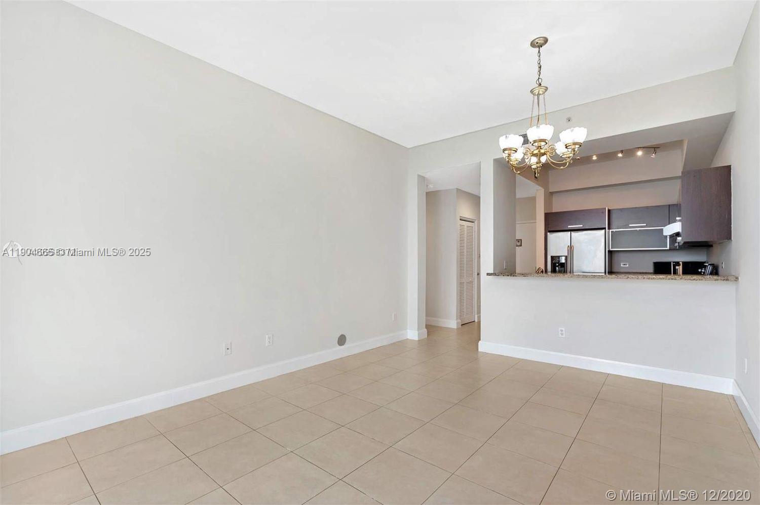 2525 Southwest 3rd Avenue, Unit 605 Miami, FL 33129 - Photo 6 of 19 a view of a kitchen with a sink and chandelier