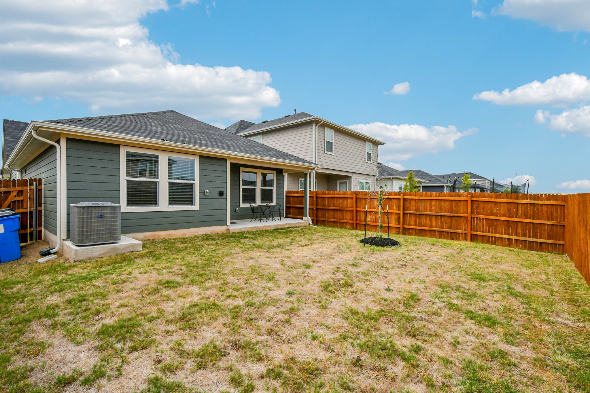 519 Sandringham Loop Kyle, TX 78640 - Photo 31 of 32 Rear view of property with a fenced backyard and a patio