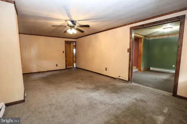 a bathroom with a sink a toilet a mirror and shower