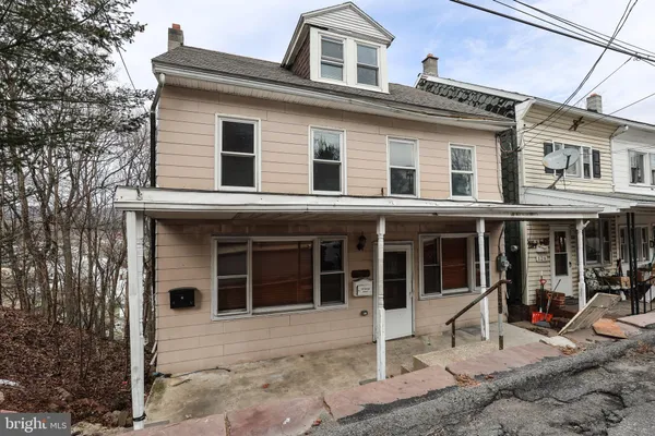 a front view of a house with a yard and porch