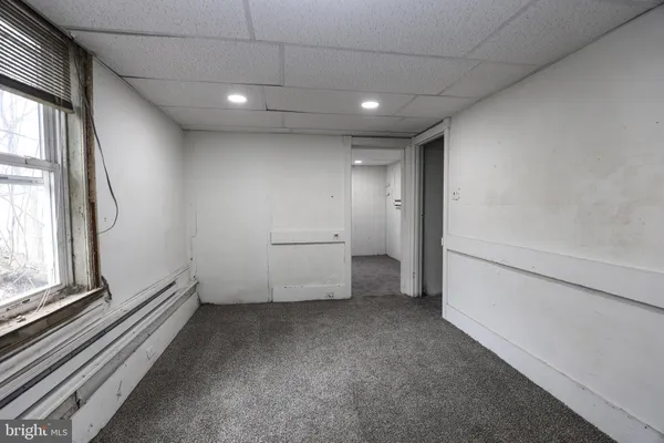 a view of a hallway to rooms