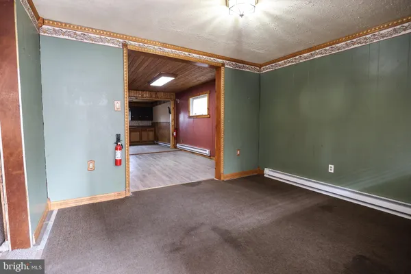 an empty room with windows and painted walls