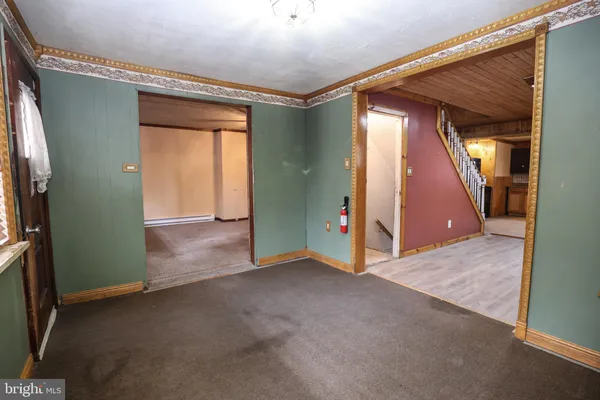 an empty room with windows and entrance