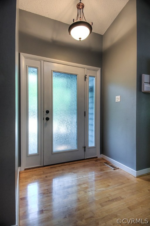 3010 Long Oaks Road Midlothian, VA 23112 - Photo 3 of 30 an empty room with wooden floor mirror and windows