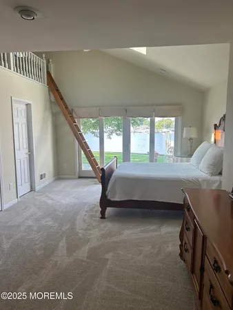 a bedroom with a bed and a large window
