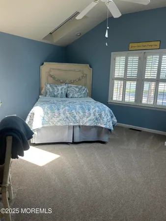 a bed sitting in a bedroom next to a window