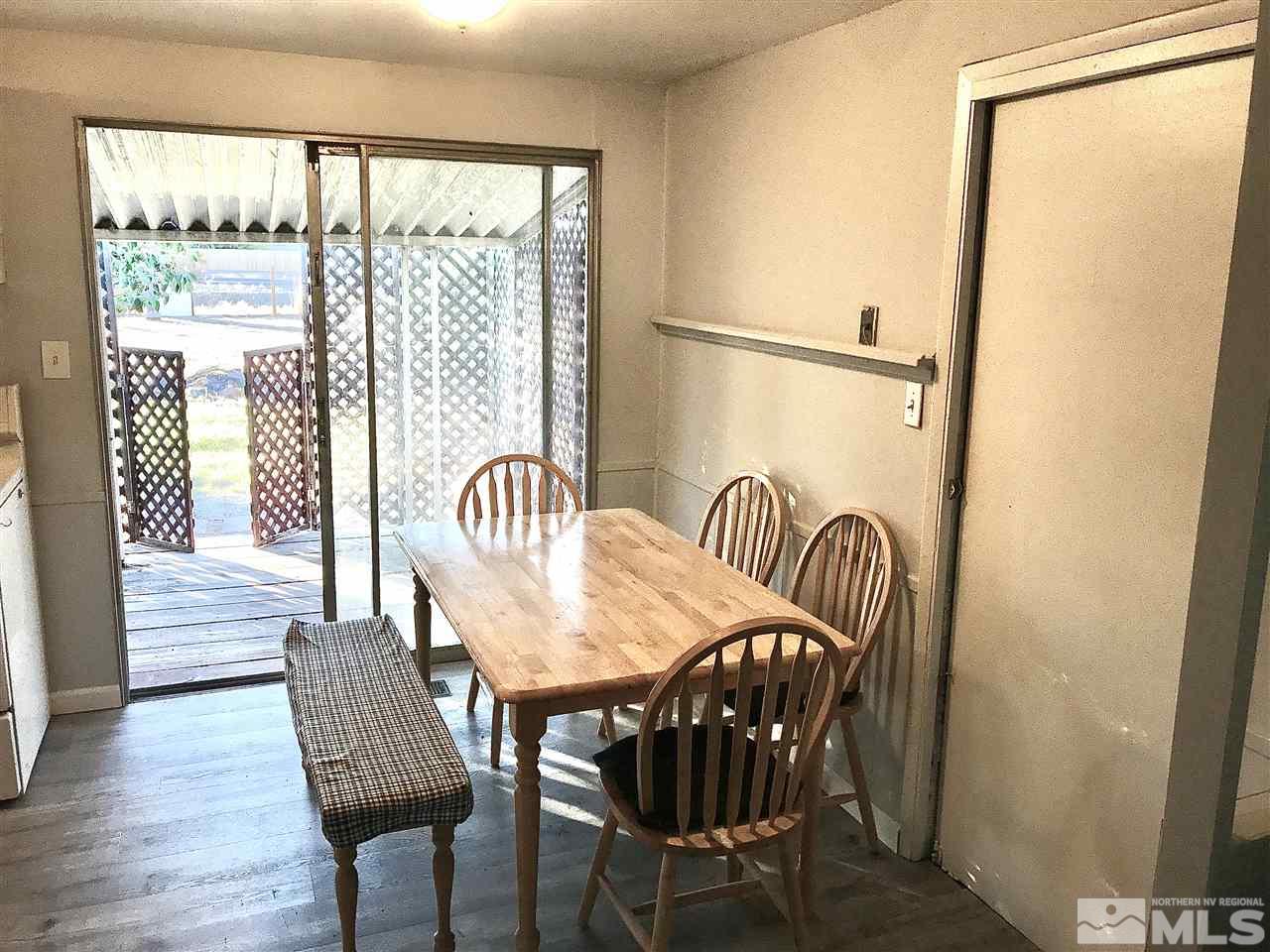 9285 Fremont Way Reno, NV 89506 - Photo 5 of 21 a view of a dining room with furniture a chandelier and wooden floor