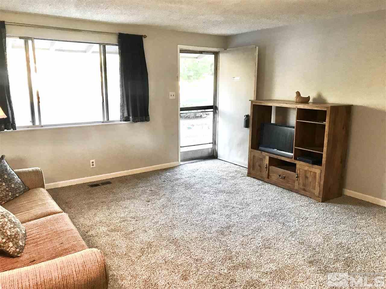 9285 Fremont Way Reno, NV 89506 - Photo 8 of 21 a living room with a couch and a flat screen tv