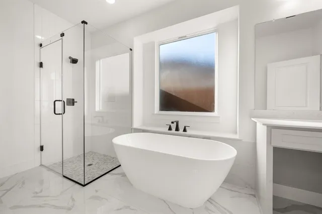 a bathroom with a bathtub sink and mirror