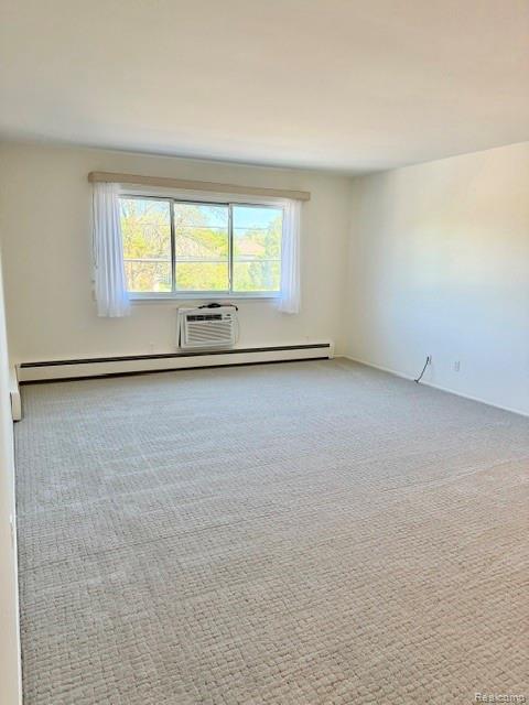 805 Plate Street, Unit 210 Rochester, MI 48307 - Photo 11 of 20 Spare room with light carpet and a baseboard heating unit