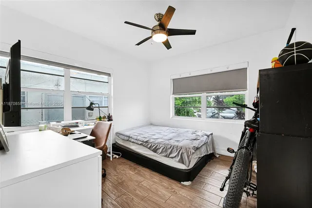 a bedroom with a bed and a television