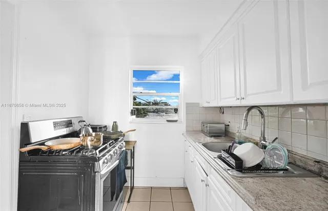 a dining room with furniture and a window