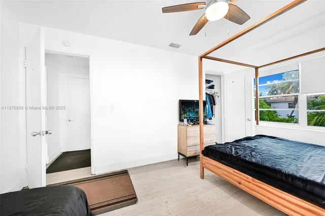 a bedroom with a bed and a view of bathroom