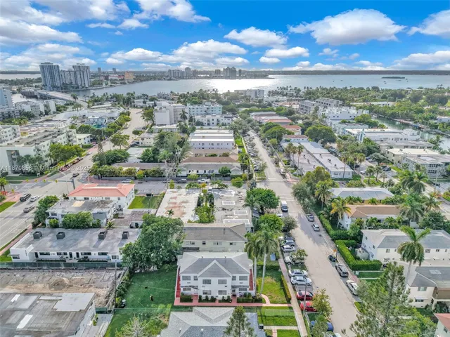 a view of a patio with couches table and chairs and potted plants
