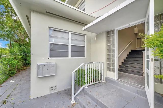 a kitchen with a refrigerator and cabinets