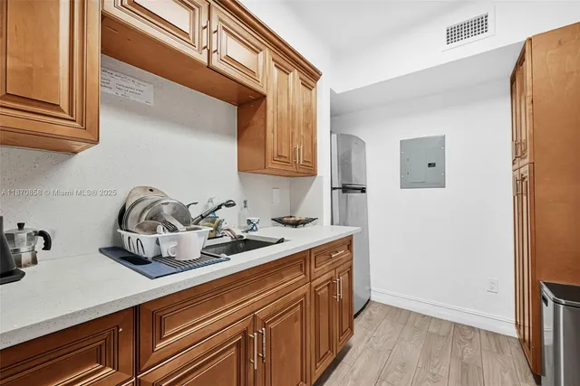 a kitchen with stainless steel appliances granite countertop a sink a stove and a refrigerator