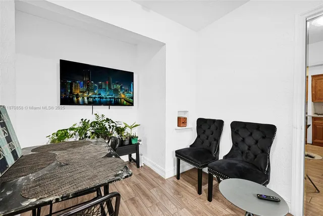 a living room with furniture and a dining table with rug