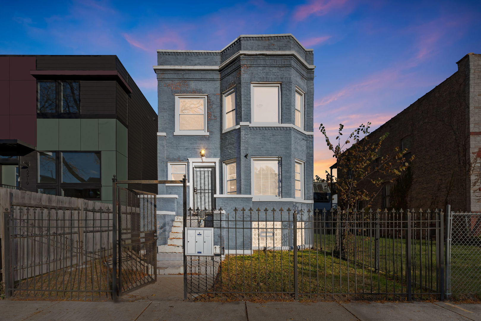 6321 South Champlain Avenue Chicago, IL 60637 - Photo 1 of 14 a front view of a house with parking space