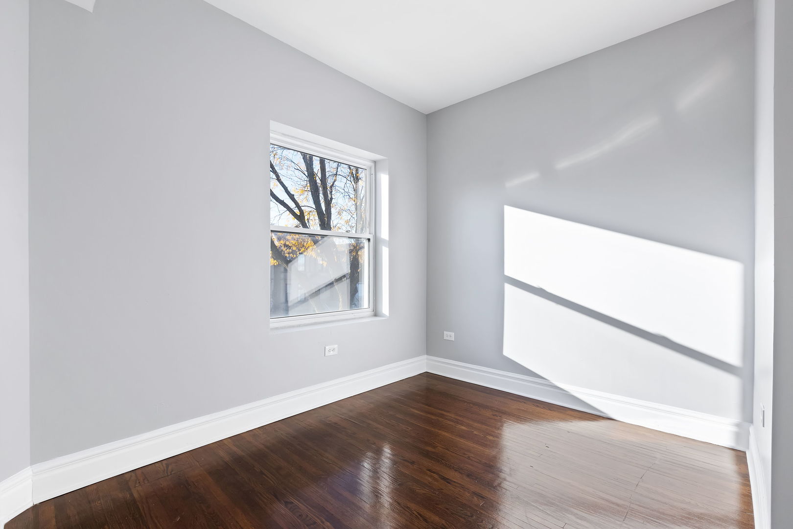 6321 South Champlain Avenue Chicago, IL 60637 - Photo 10 of 14 an empty room with wooden floor and windows