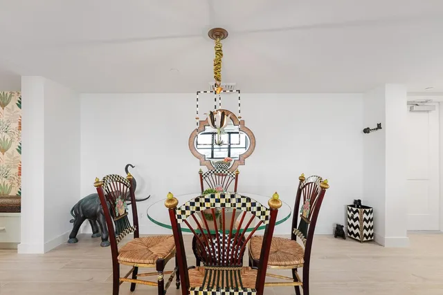 a view of a dining room with furniture and a chandelier