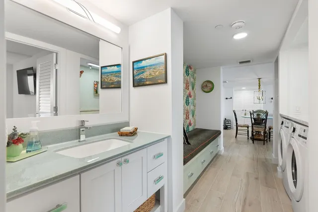 a bed sitting in a spacious bedroom next to a window