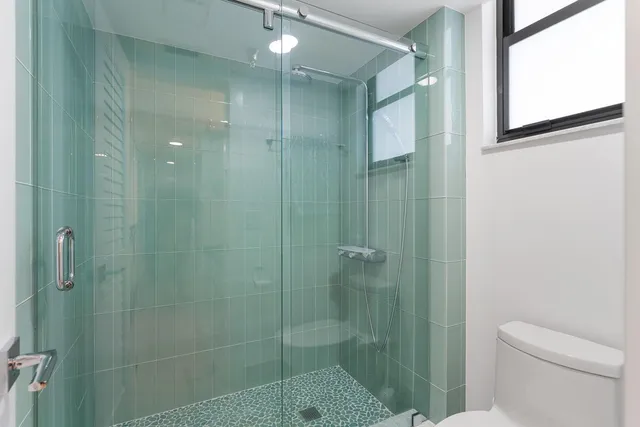 a living room filled with furniture and a potted plant