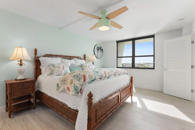 a bedroom with a bed mirror and couch