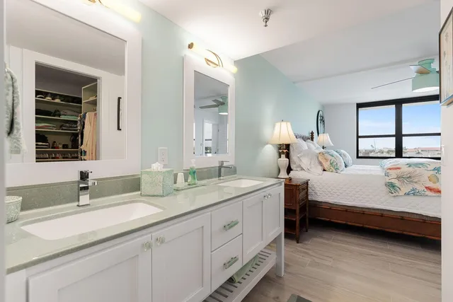 a bathroom with a granite countertop sink double and mirror
