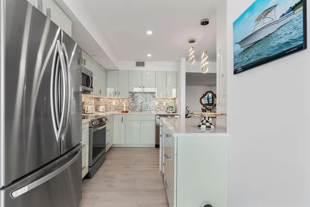 a kitchen with a sink stainless steel appliances and cabinets