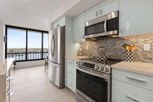 a kitchen with granite countertop a stove and a microwave