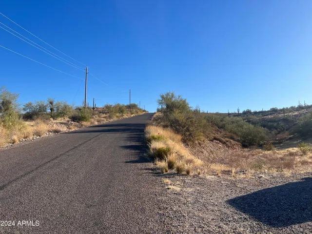 a view of a house with a yard and mountain view