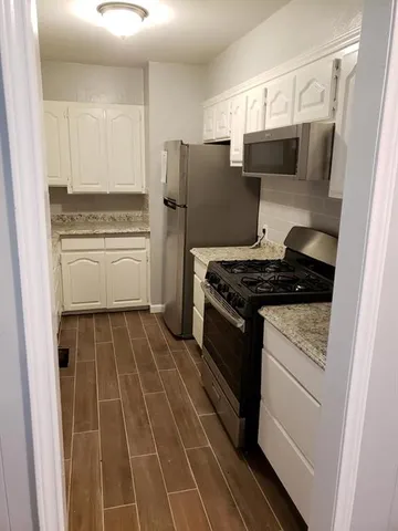 a kitchen with a stove and a refrigerator