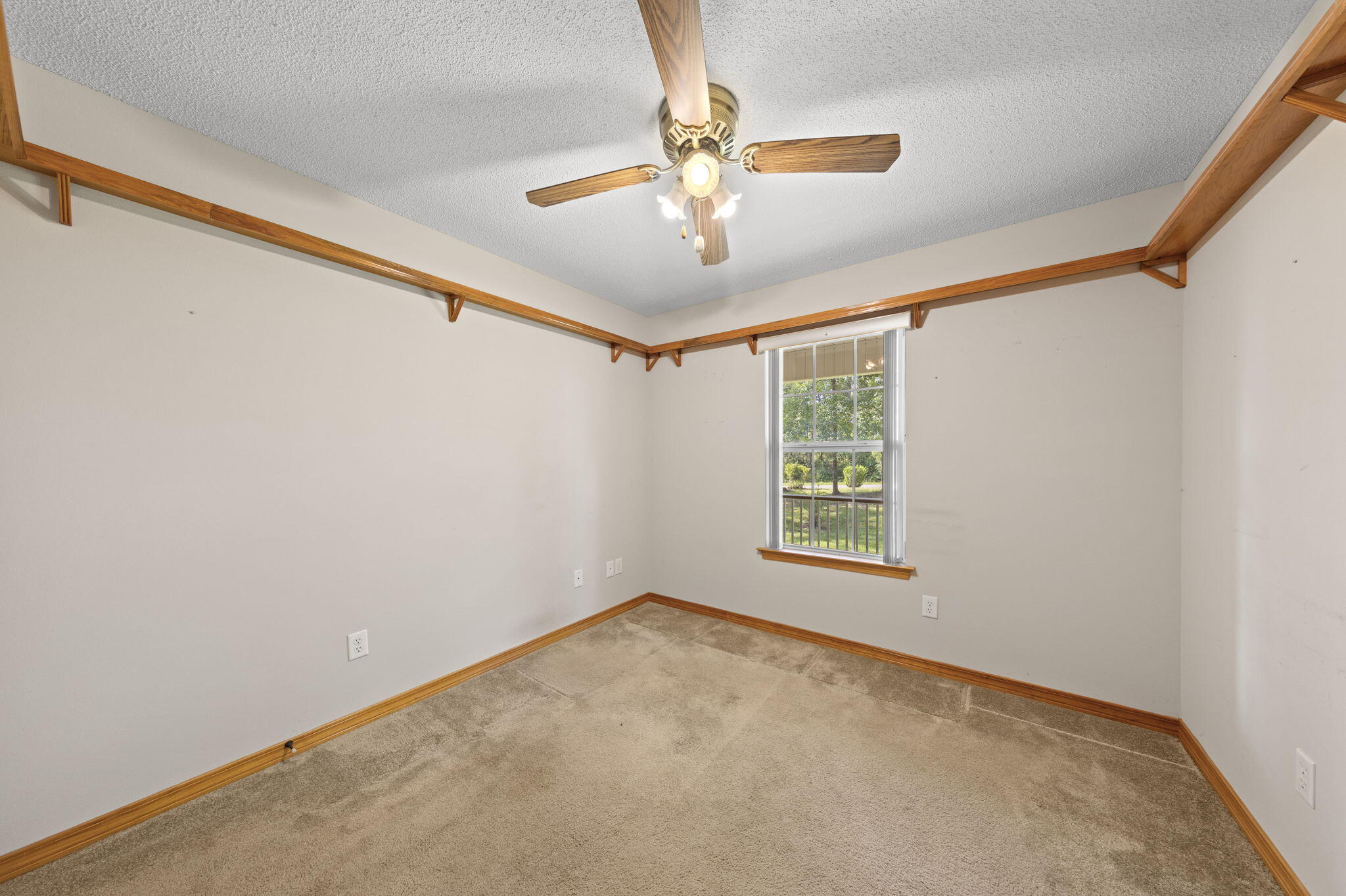 3435 Fl-2 Laurel Hill Laurel Hill, FL 32567 - Photo 14 of 39 a view of a big room with windows and chandelier fan