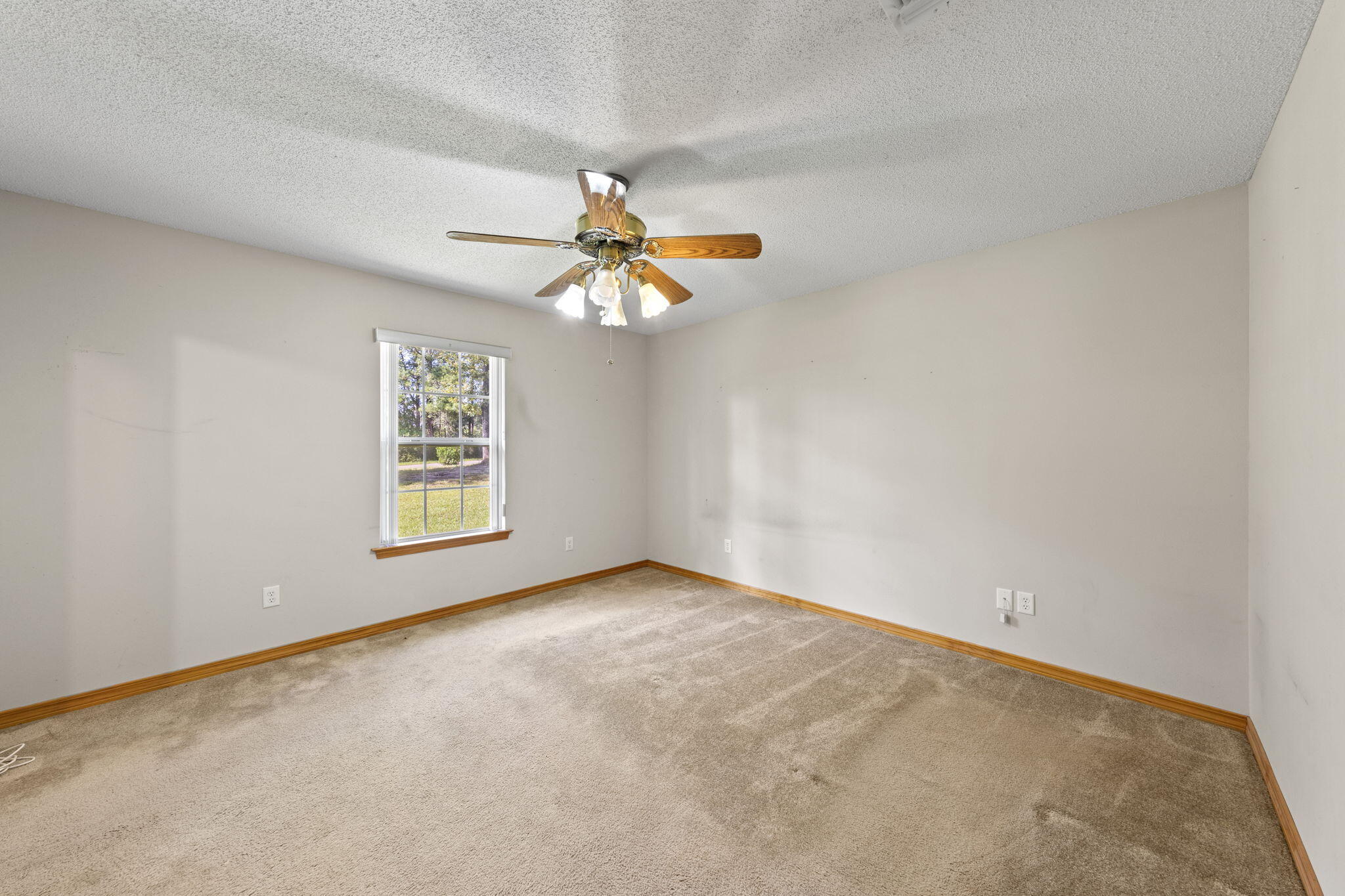 3435 Fl-2 Laurel Hill Laurel Hill, FL 32567 - Photo 18 of 39 an empty room with a window and a fan