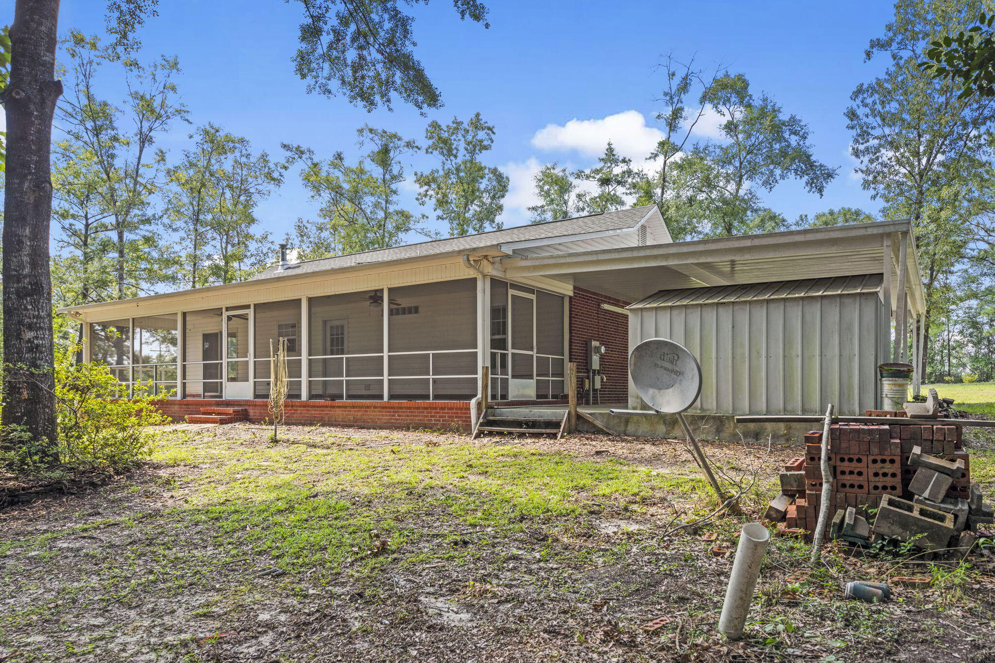 3435 Fl-2 Laurel Hill Laurel Hill, FL 32567 - Photo 2 of 39 a front view of a house with garden and patio