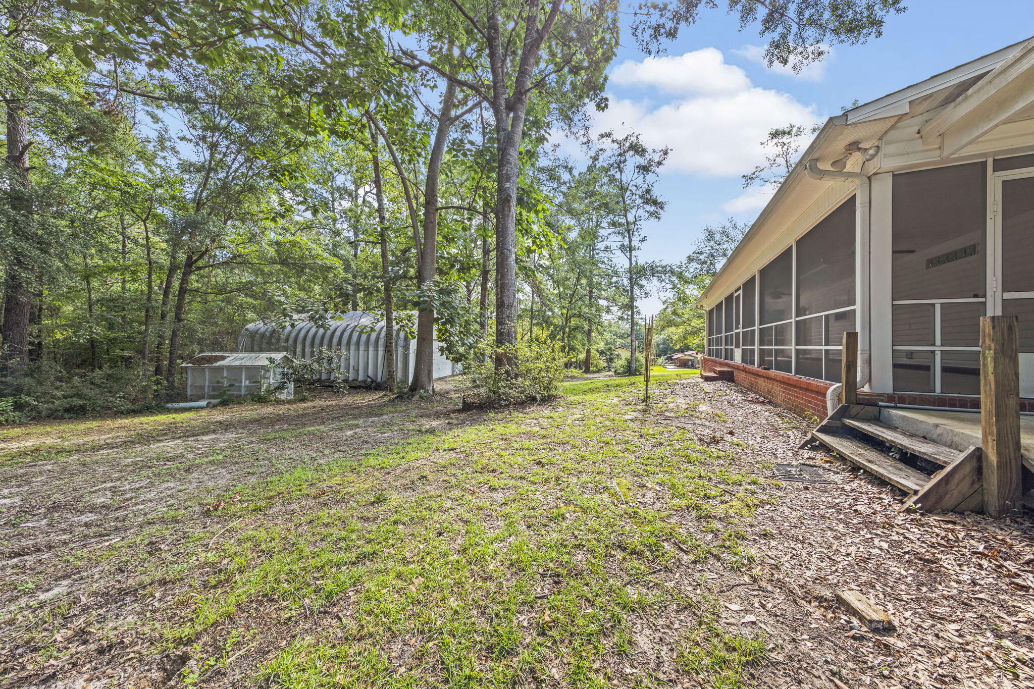 3435 Fl-2 Laurel Hill Laurel Hill, FL 32567 - Photo 22 of 39 a backyard of a house with lots of green space