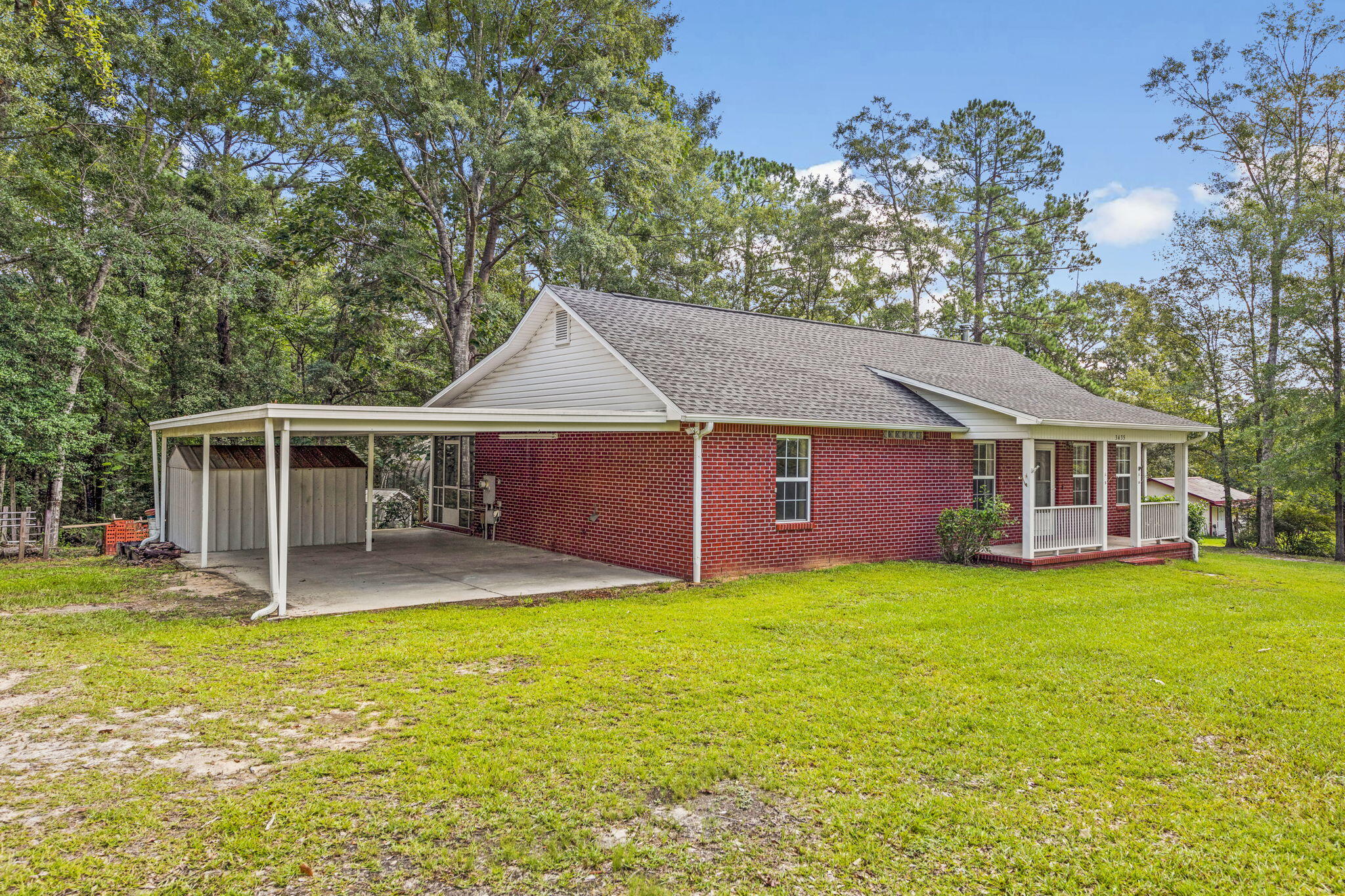 3435 Fl-2 Laurel Hill Laurel Hill, FL 32567 - Photo 32 of 39 a front view of a house with a garden