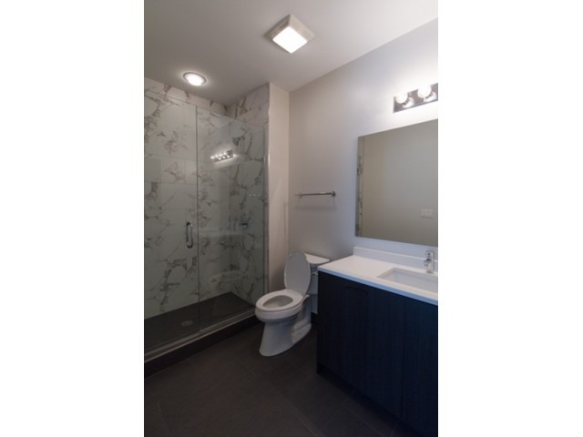 4027 North Broadway, Unit 504 Chicago, IL 60613 - Photo 4 of 7 a bathroom with a toilet a sink and shower