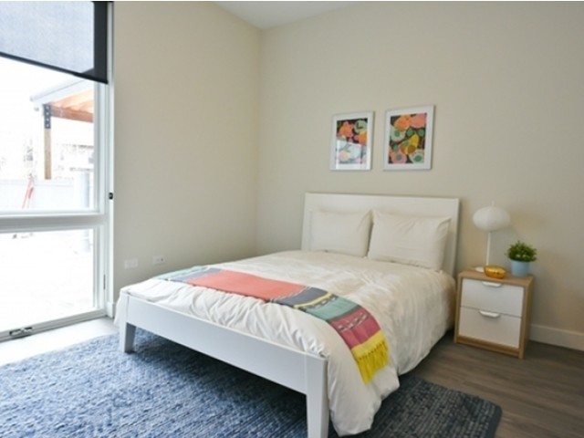 4027 North Broadway, Unit 504 Chicago, IL 60613 - Photo 7 of 7 a bedroom with a bed and a window
