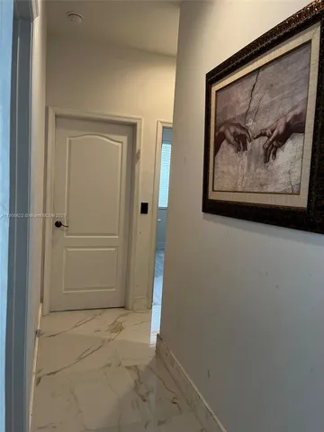 an empty room with a painting on the wall