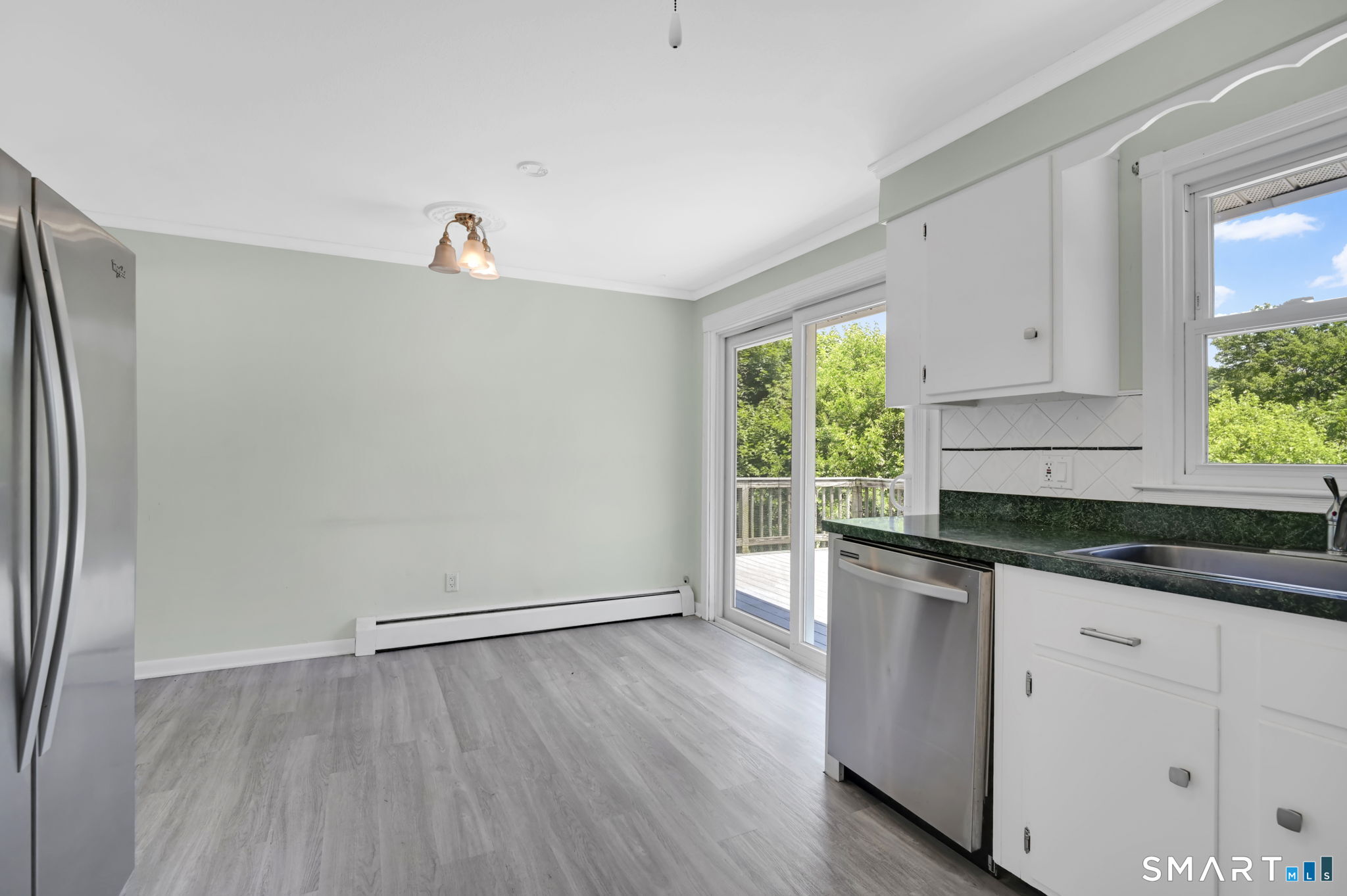 7 Rogers Drive Meriden, CT 06450 - Photo 16 of 40 a kitchen with granite countertop white cabinets and wooden floor