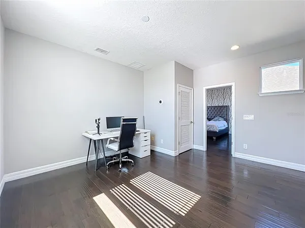 a bedroom with a bed tv and window