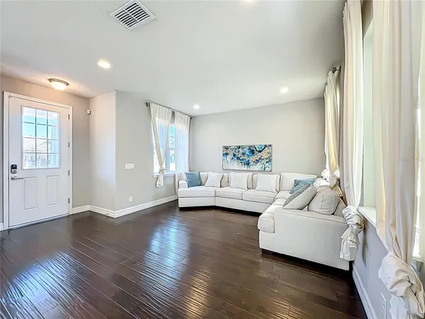 a living room with furniture and kitchen view