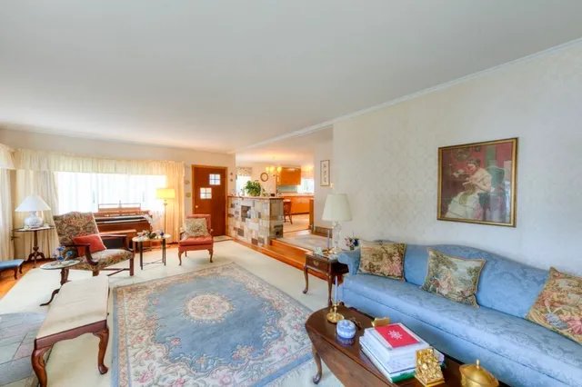 a living room with furniture and a large window or couch