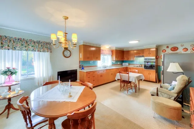 a view of a dining room with furniture a chandelier and wooden floor