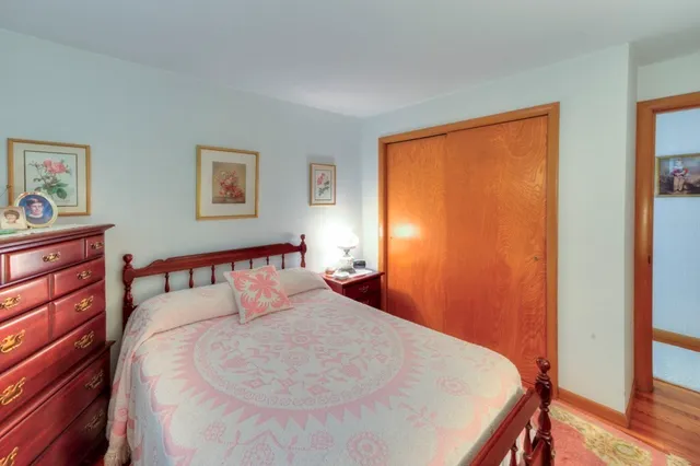 a bedroom with a bed and a dresser