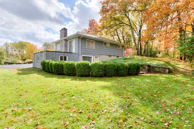 a front view of a house with a garden